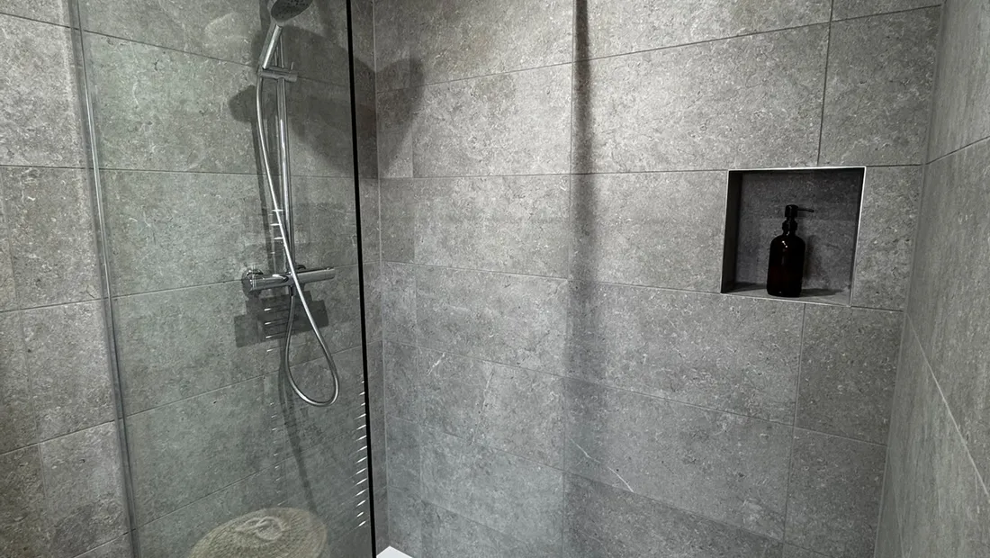 Level-access shower in a Horsham annex we converted, with a glass screen, a tray set flush with the floor and a recessed niche
