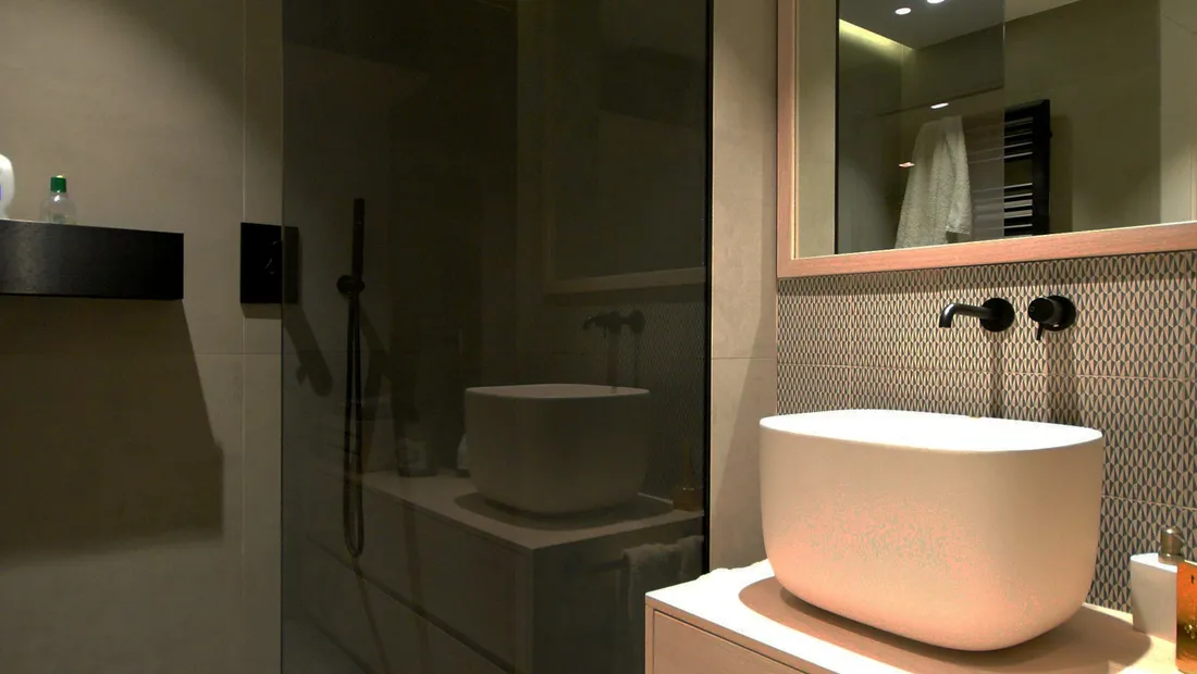 Dark tiled bathroom with a round counter-top basin and large mirror
