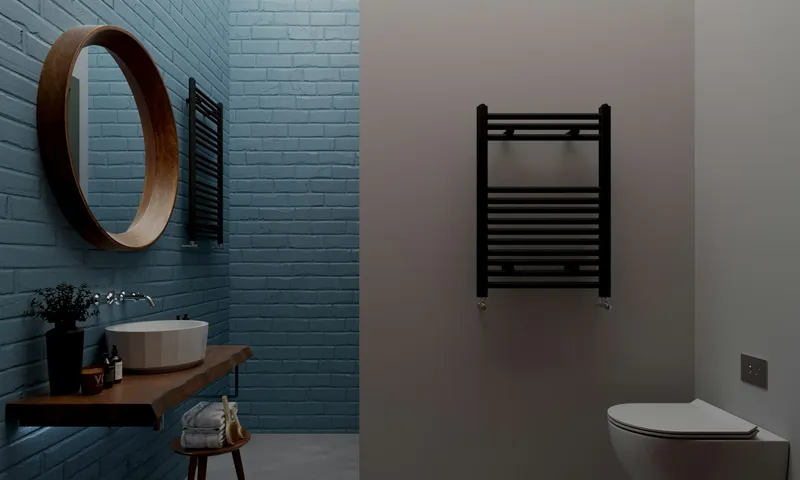 Dark tiled bathroom with a round mirror, wall-hung basin and heated towel rail