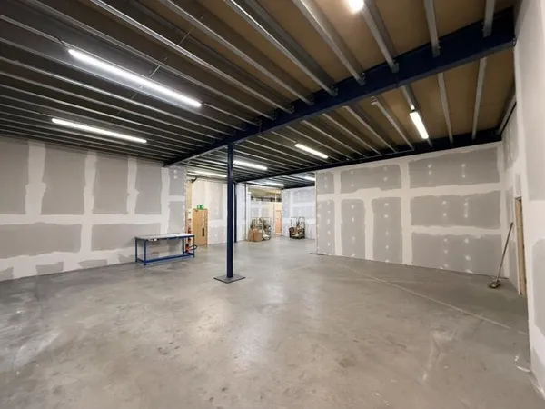 The finished space under the mezzanine, with plasterboard walls taped and jointed ready for decoration and the floor cleared