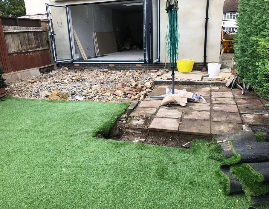 One of our single-storey rear extensions in Sussex mid-build, with the bifold doors in and the old patio coming up